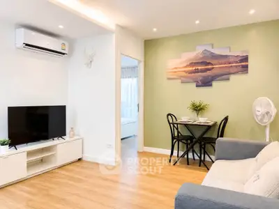 Modern living room with stylish decor and open layout, featuring a cozy seating area and dining space.