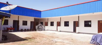 Modern single-story building with multiple units and blue roofing, ideal for commercial or residential use.