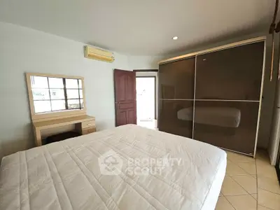 Spacious bedroom with modern wardrobe and cozy ambiance