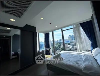 Modern bedroom with city view and large windows in high-rise apartment
