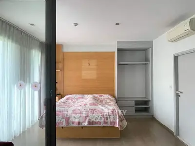 Spacious bedroom with large windows and modern air conditioning unit