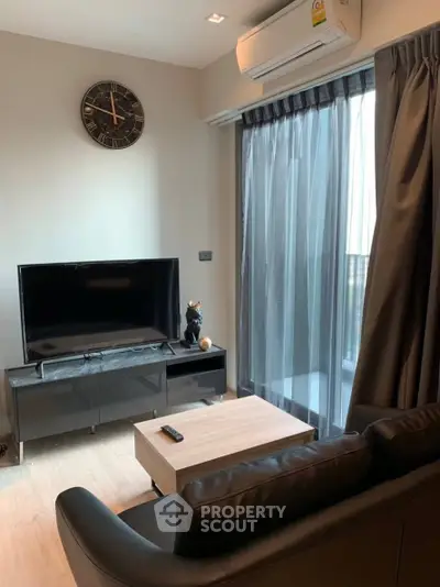 Modern living room with sleek furniture and large window for natural light.