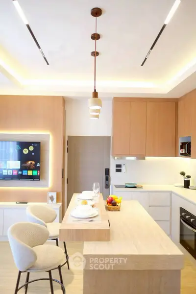 Modern kitchen with sleek design, featuring a breakfast bar and integrated appliances.