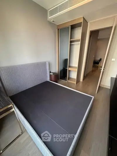 Modern bedroom with sleek design and built-in wardrobe in a stylish apartment.