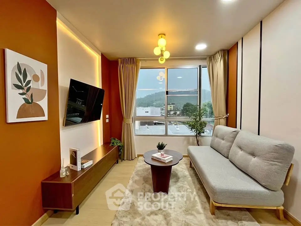 Modern living room with stylish decor and large window offering scenic views.