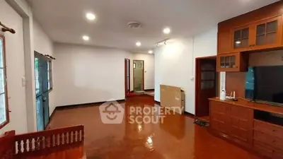 Spacious living room with wooden flooring and built-in cabinets