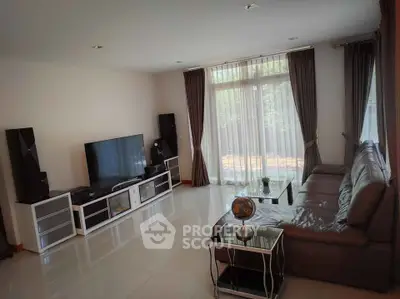 Spacious living room with modern decor and large windows for natural light.