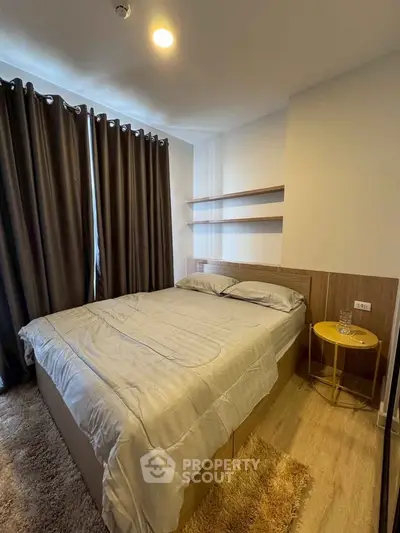 Cozy bedroom with modern decor and natural light, featuring a comfortable bed and stylish curtains.