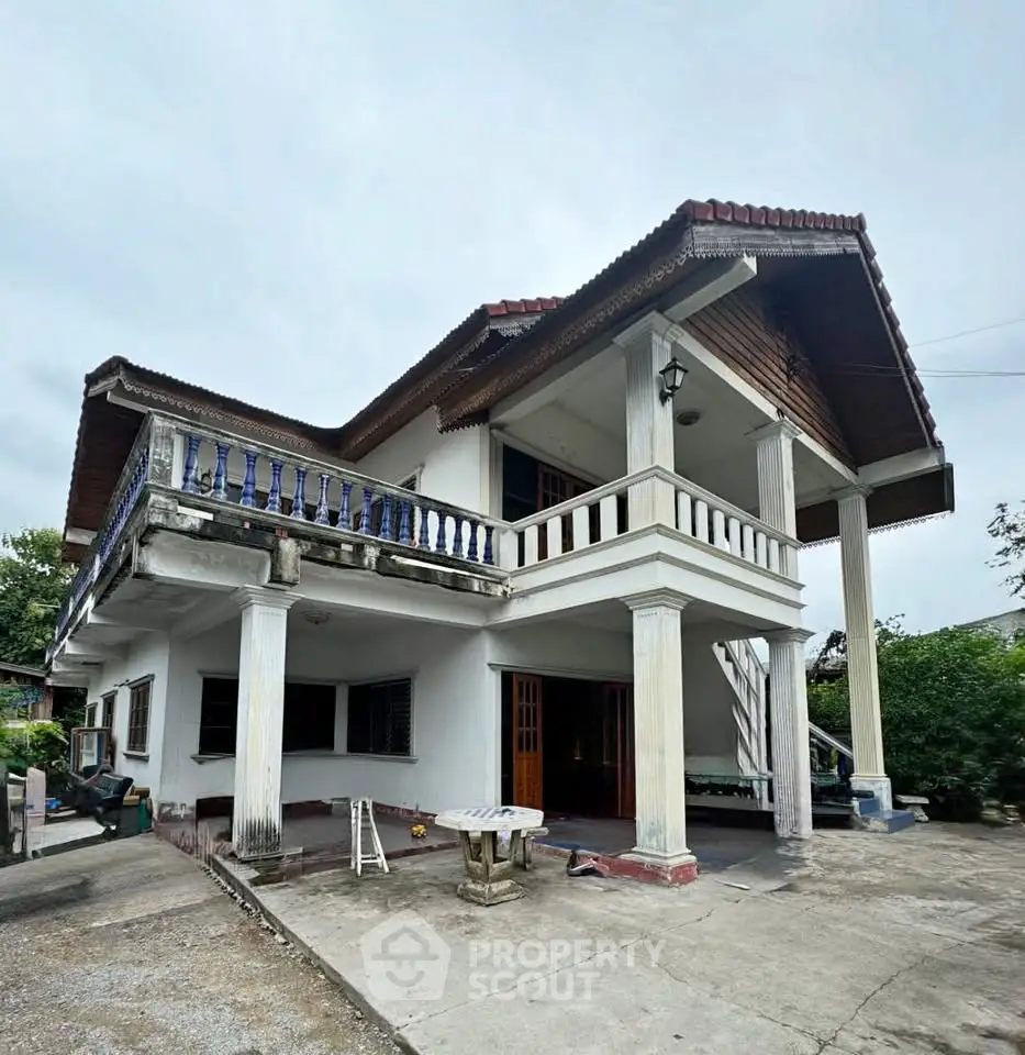 Charming two-story house with spacious balcony and classic architectural design, perfect for family living.