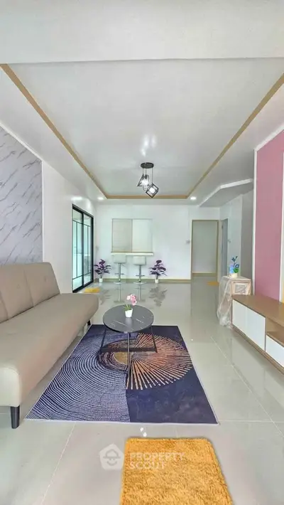 Modern living room with stylish decor and contemporary furniture, featuring a sleek sofa and elegant coffee table.