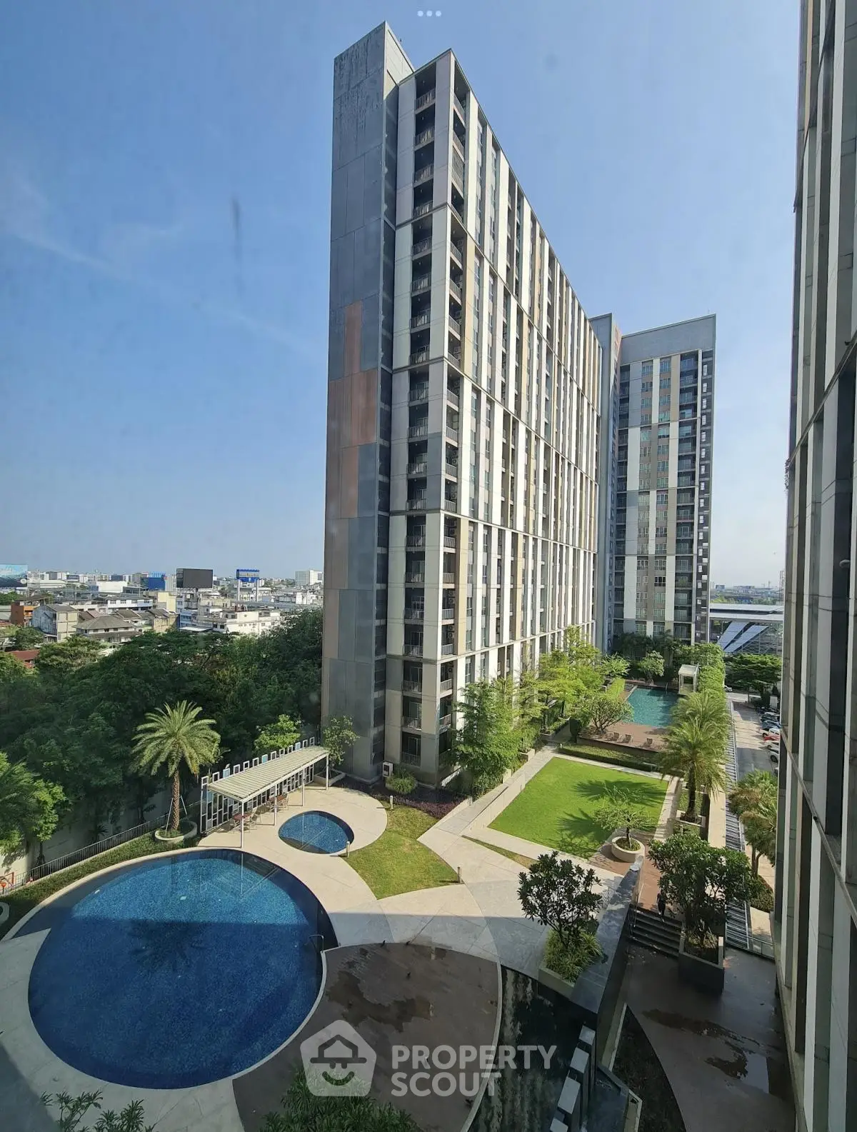 Luxurious high-rise apartment complex with pool and garden view