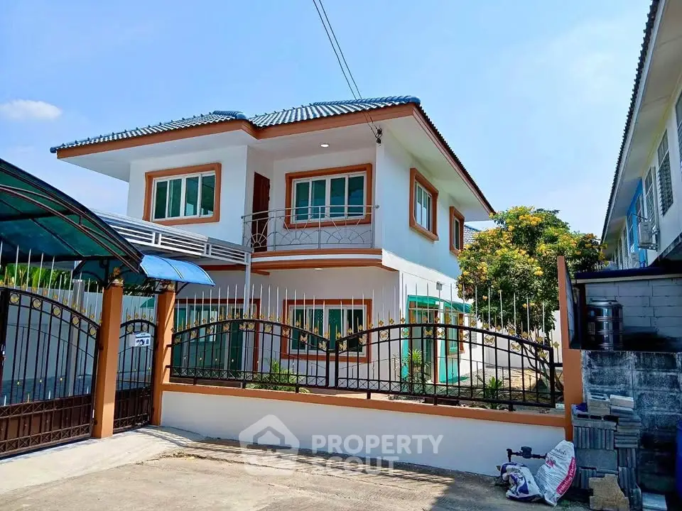 Charming two-story house with modern design and gated entrance in a serene neighborhood.