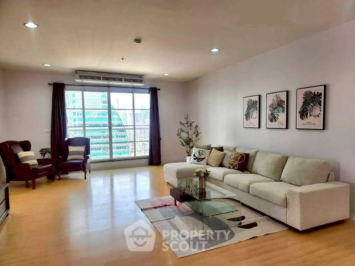 Spacious living room with modern decor and city view window