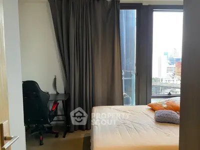 Modern bedroom with city view and study desk, perfect for urban living.