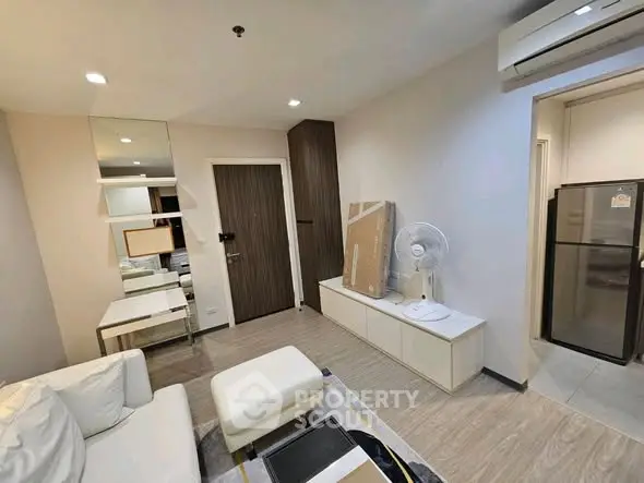Modern living room with sleek furniture and air conditioning, perfect for urban living.