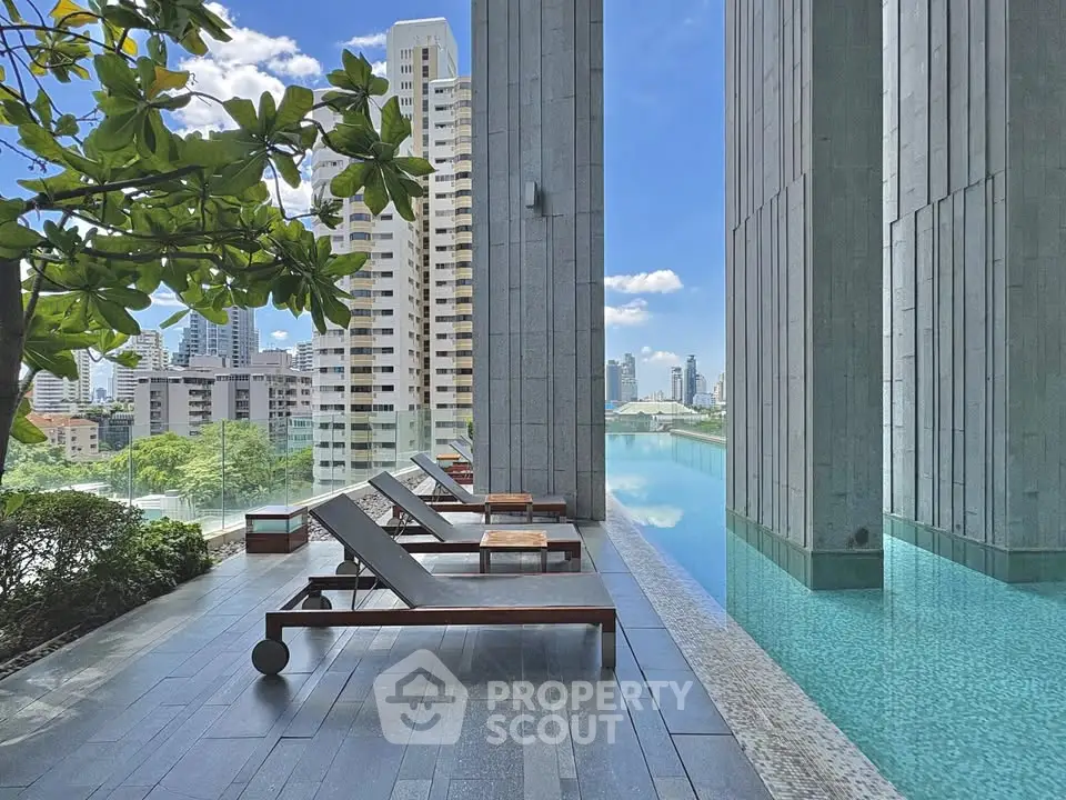 Luxurious high-rise pool area with stunning city views and modern lounge chairs.