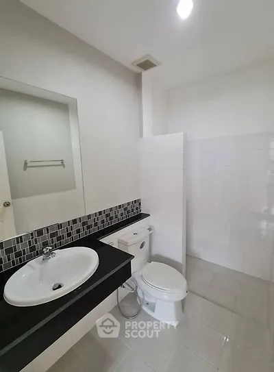 Modern bathroom with sleek design and tiled walls