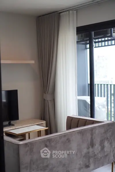 Modern living room with sleek sofa and city view balcony