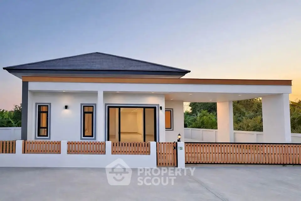 Modern single-story home with sleek design and spacious driveway