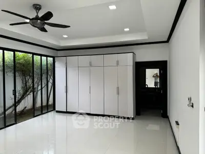 Spacious bedroom with large wardrobe and garden view