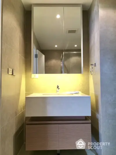 Modern bathroom with sleek vanity and large mirror