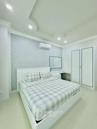 Modern bedroom with sleek design, featuring a comfortable bed and stylish decor.