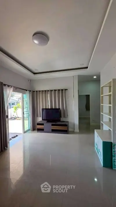 Spacious living room with modern decor and large windows for natural light.