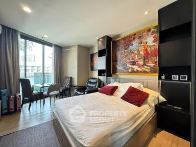 Modern bedroom with balcony, stylish decor, and vibrant artwork in a luxury apartment.