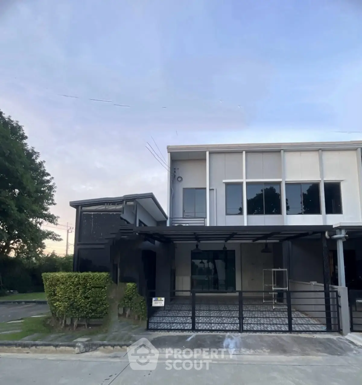 Modern two-story building with sleek design and spacious driveway