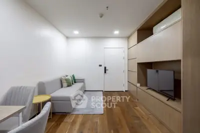 Modern living room with sleek furniture and wooden flooring, perfect for urban living.