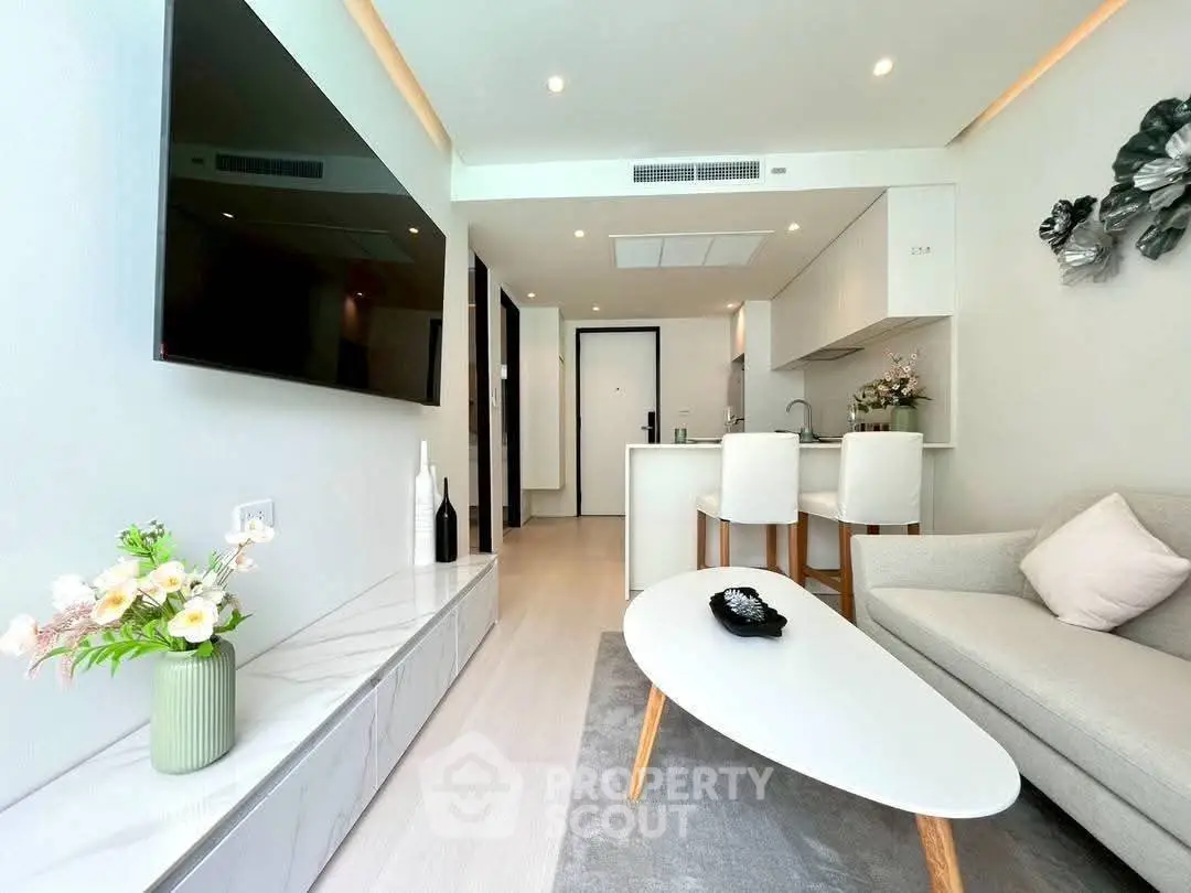 Modern living room with sleek design, open kitchen layout, and stylish decor in a contemporary apartment.