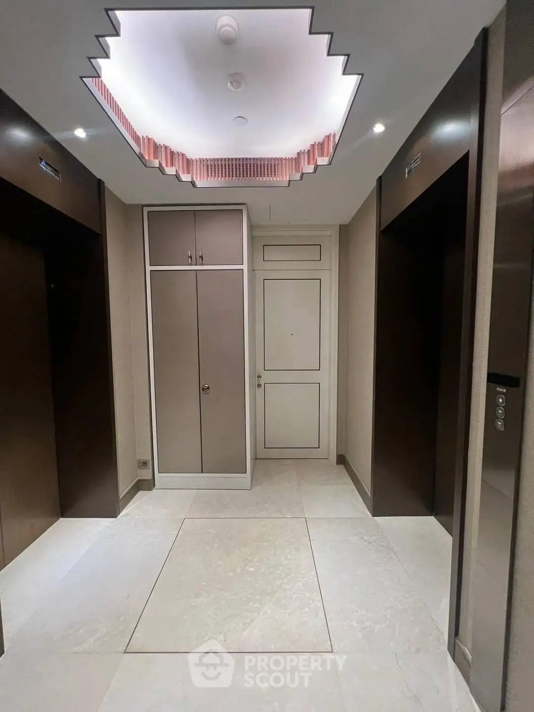 Elegant elevator lobby with modern ceiling design and sleek finishes.