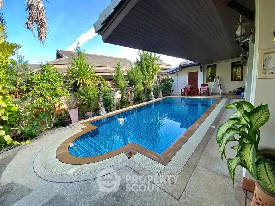 Luxurious private pool area with lush greenery and modern design