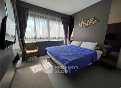 Modern bedroom with large windows and stylish decor