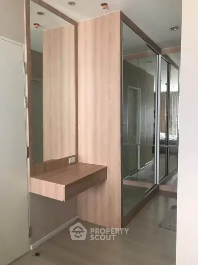 Modern hallway with mirrored wardrobe and wooden accents in stylish apartment