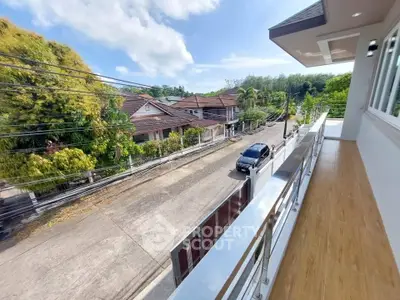 Spacious balcony with scenic street view in a serene neighborhood