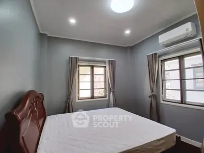 Cozy bedroom with natural light and modern air conditioning unit.