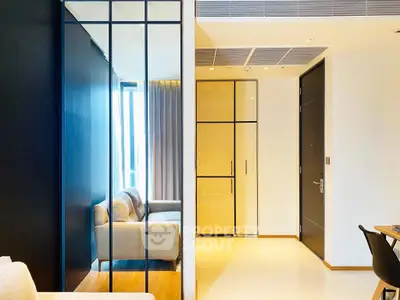 Modern living room with sleek design and large windows offering natural light.