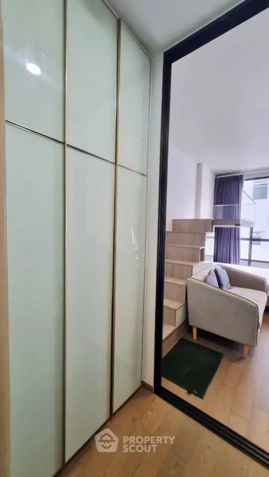 Modern interior with sleek storage and cozy seating area in a stylish apartment