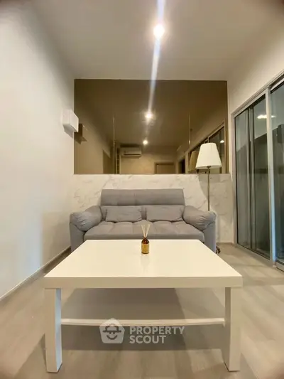 Modern living room with sleek design and cozy gray sofa