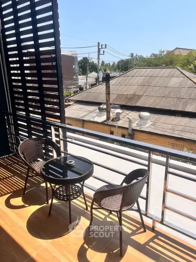 Charming balcony with seating and scenic view, perfect for relaxation.