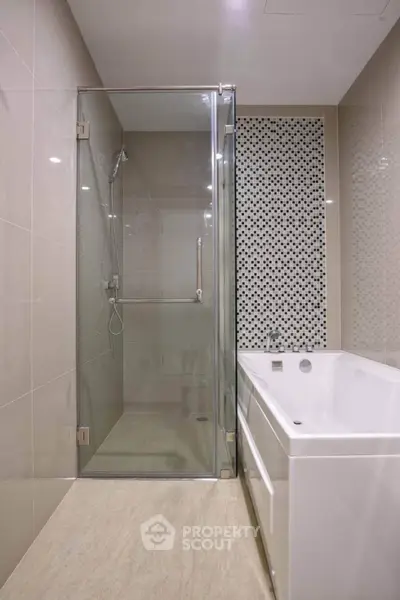Modern bathroom with glass shower and stylish bathtub