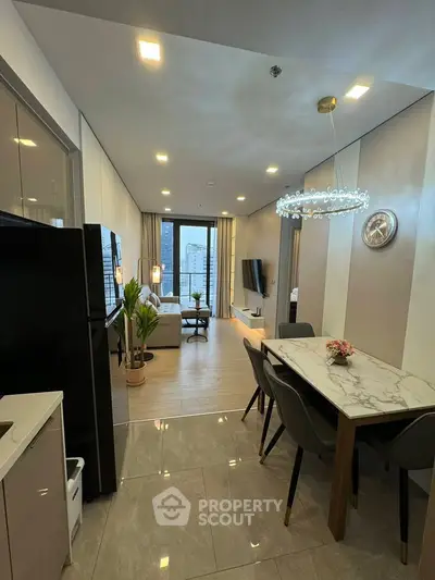 Modern open-plan living and dining area with elegant decor and city view.