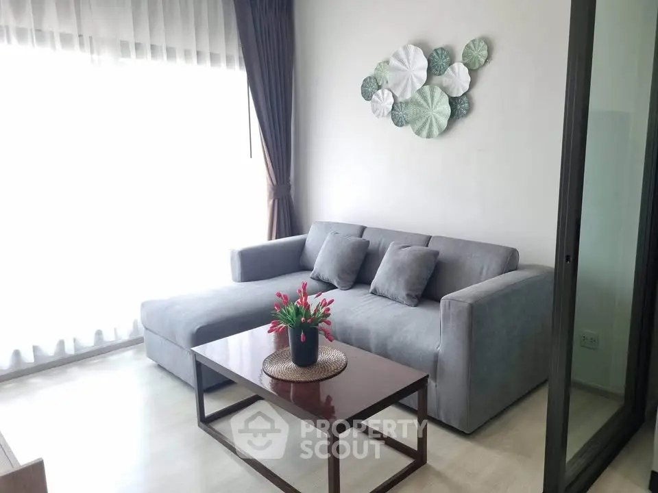 Modern living room with stylish gray sofa and elegant decor, perfect for relaxation and comfort.