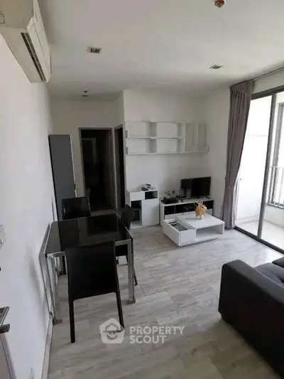 Modern living room with sleek furniture and large windows in a stylish apartment.