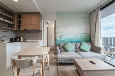 Modern living room with stylish decor and open kitchen layout in a cozy apartment.