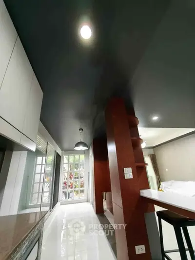 Modern interior with sleek design and open layout, featuring a stylish kitchen and living area.
