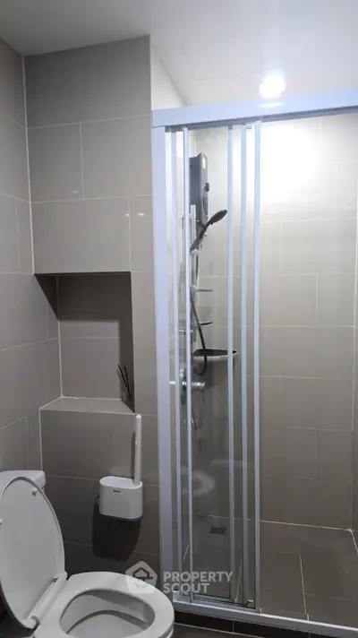 Modern bathroom with sleek shower enclosure and tiled walls