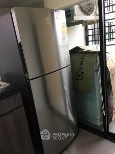 Modern kitchen with sleek Electrolux refrigerator and ample storage space.