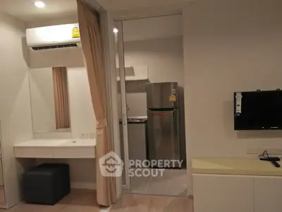 Modern apartment interior with open kitchen and living area, featuring sleek appliances and contemporary design.
